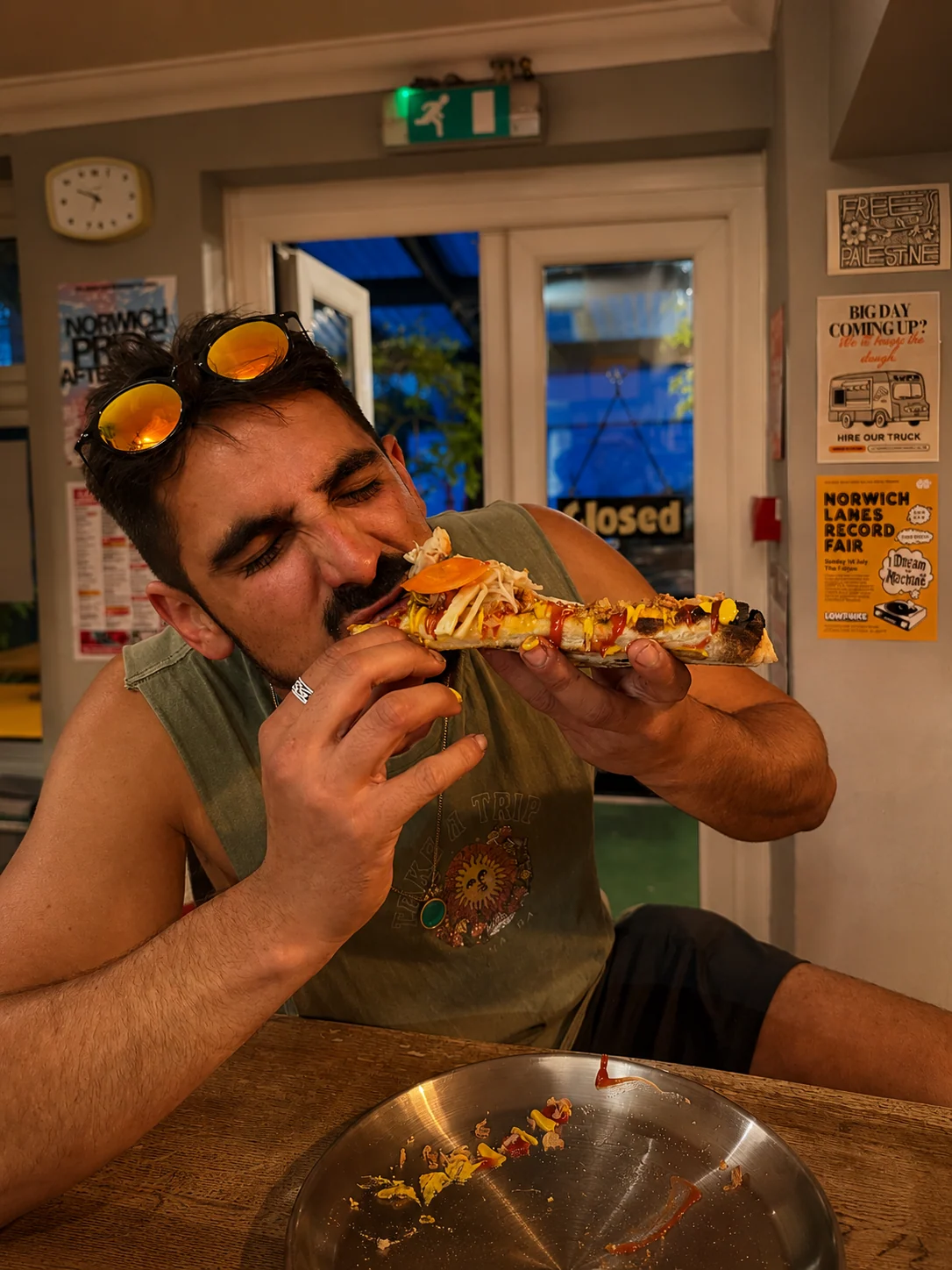 A diner enjoying a slice of Lupa pizza