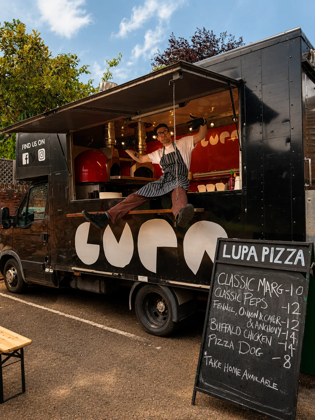 Black Lupa Pizza food truck with its menu board