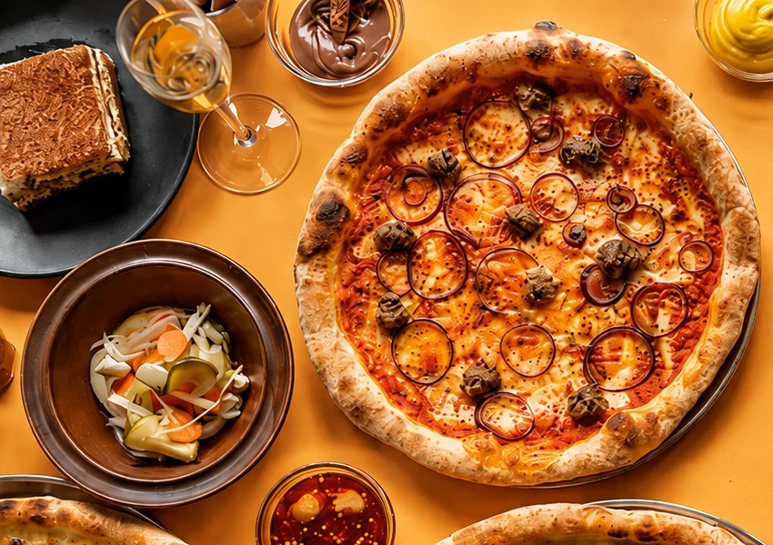 Lupa table with tiramisu, house pickles, dip and pizza